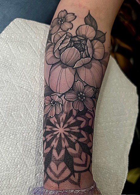 Florals and mandala work down the forearm