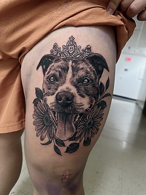 Crowned dog portrait among florals, thigh