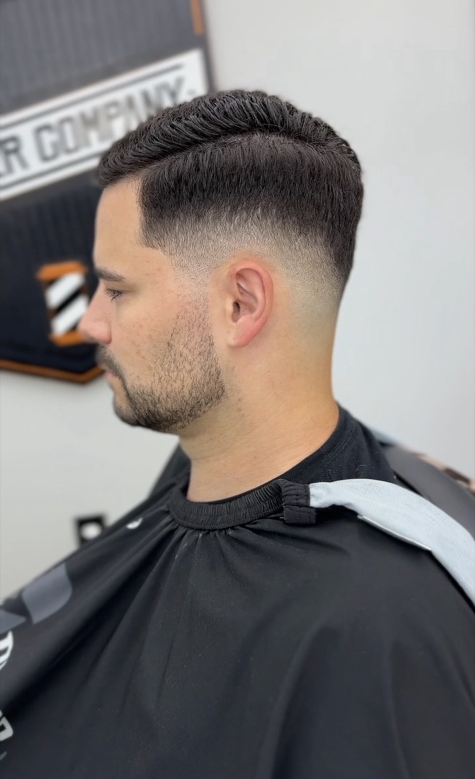 Side-part combover with a razor-sharp taper