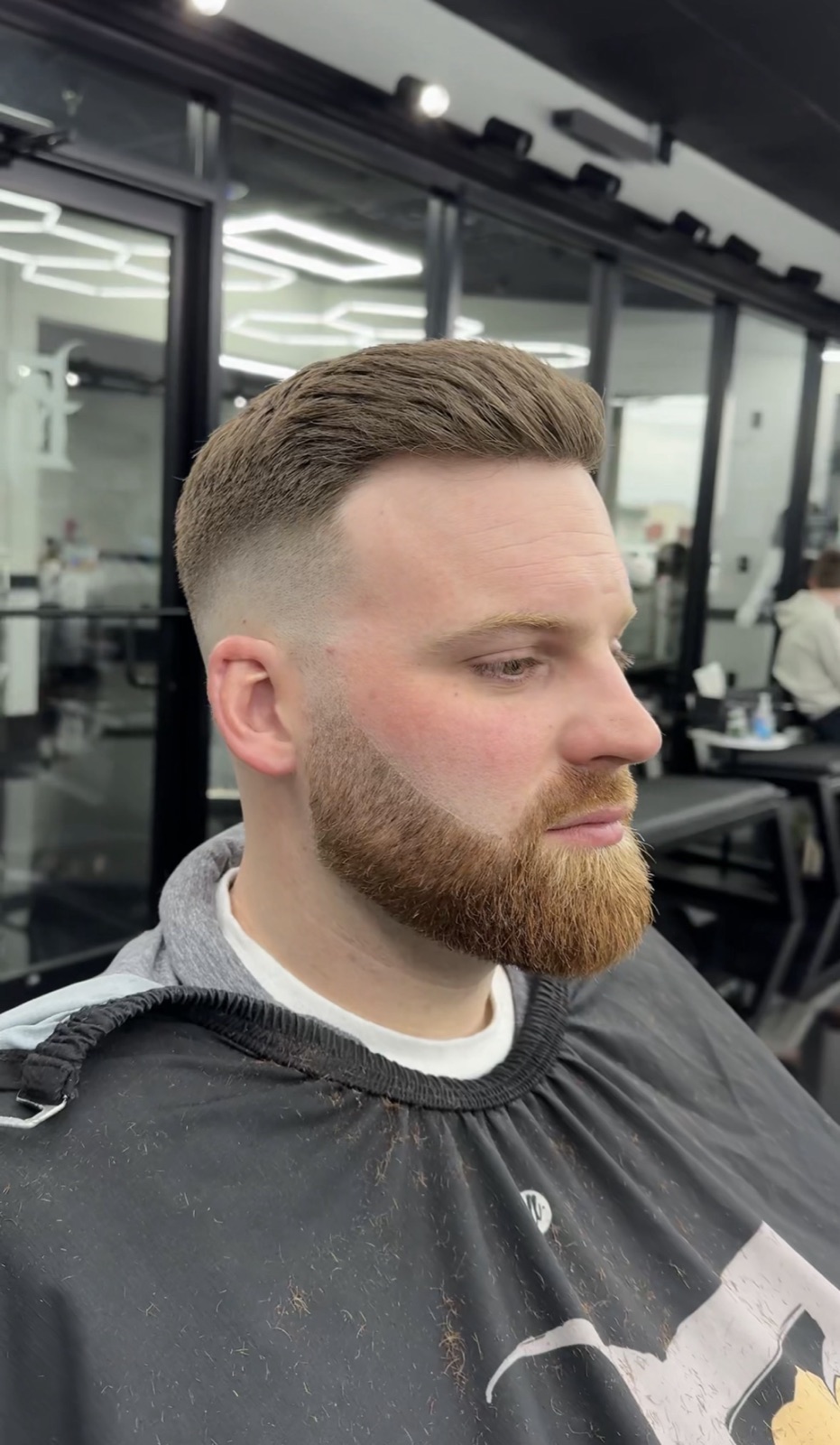 Slicked-back fade with a blended beard