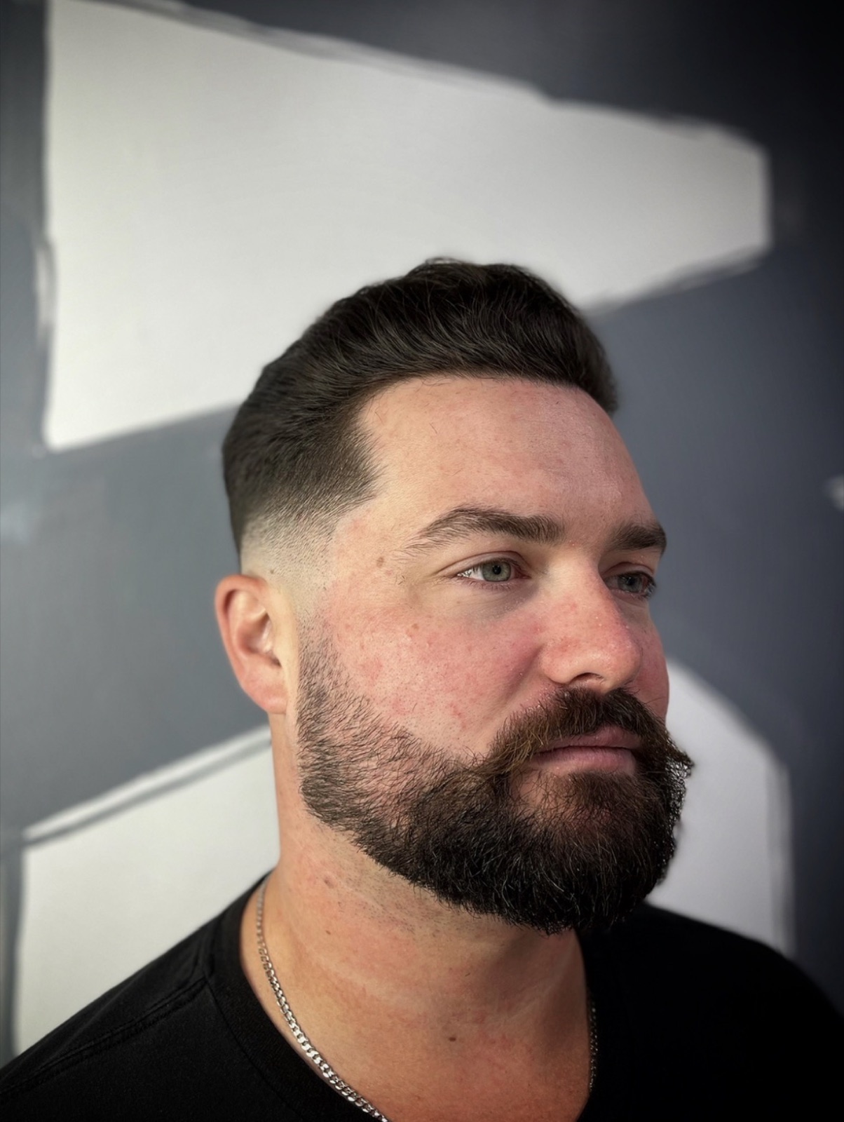 Pompadour blend with a full dark beard trim