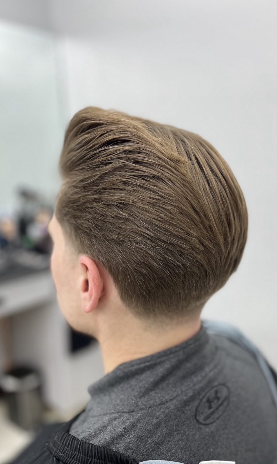 Back view — tapered nape under blow-dried volume