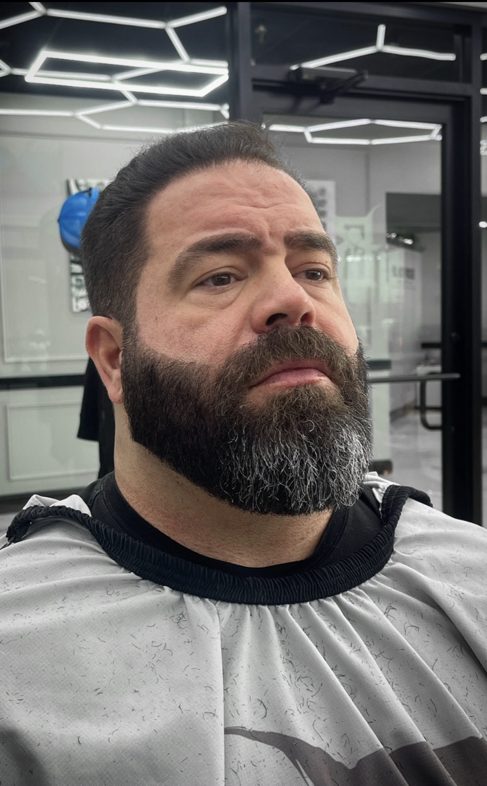 Dense beard shape-up with a tight crop