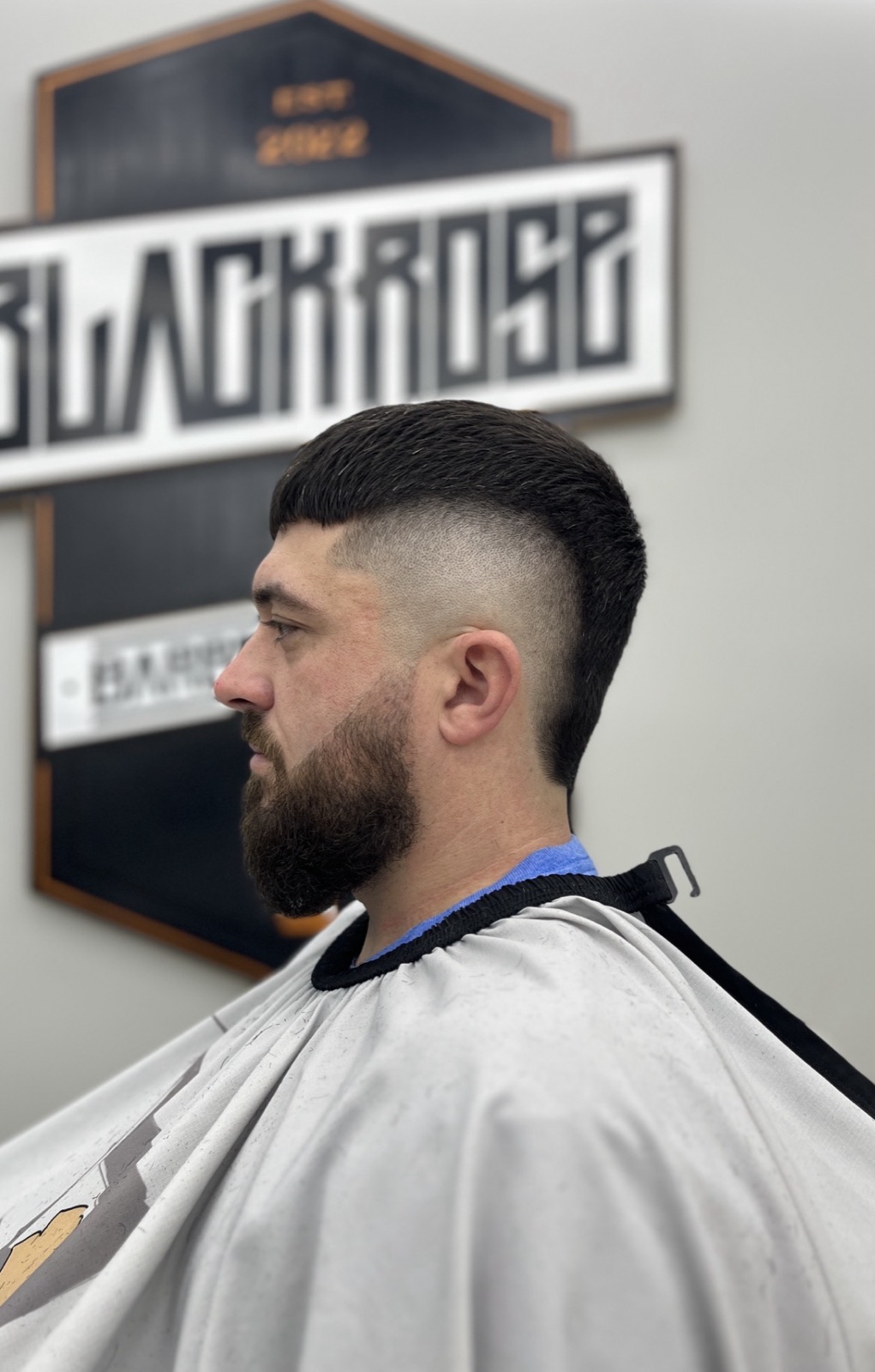 Burst-fade mullet with a shaped beard