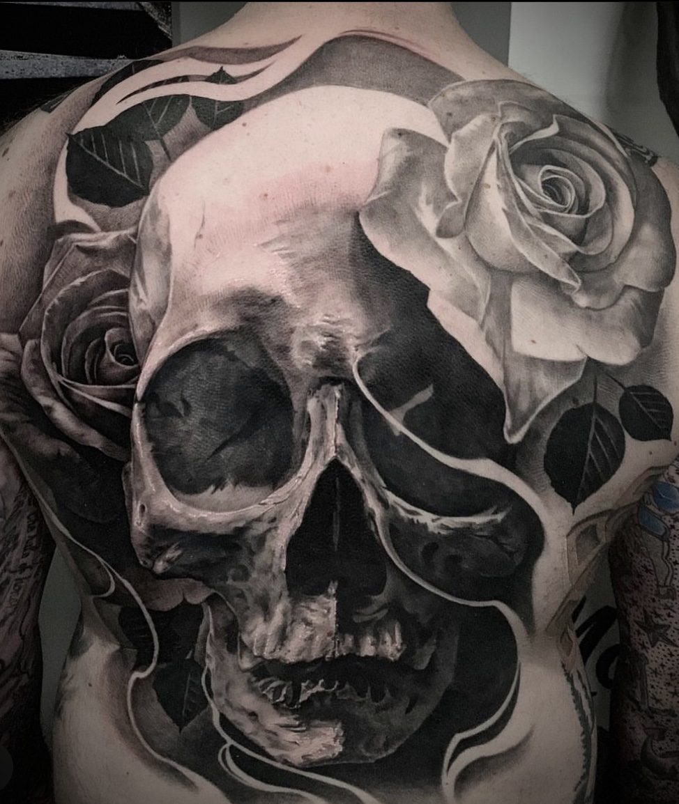 Large skull among roses, across the shoulder
