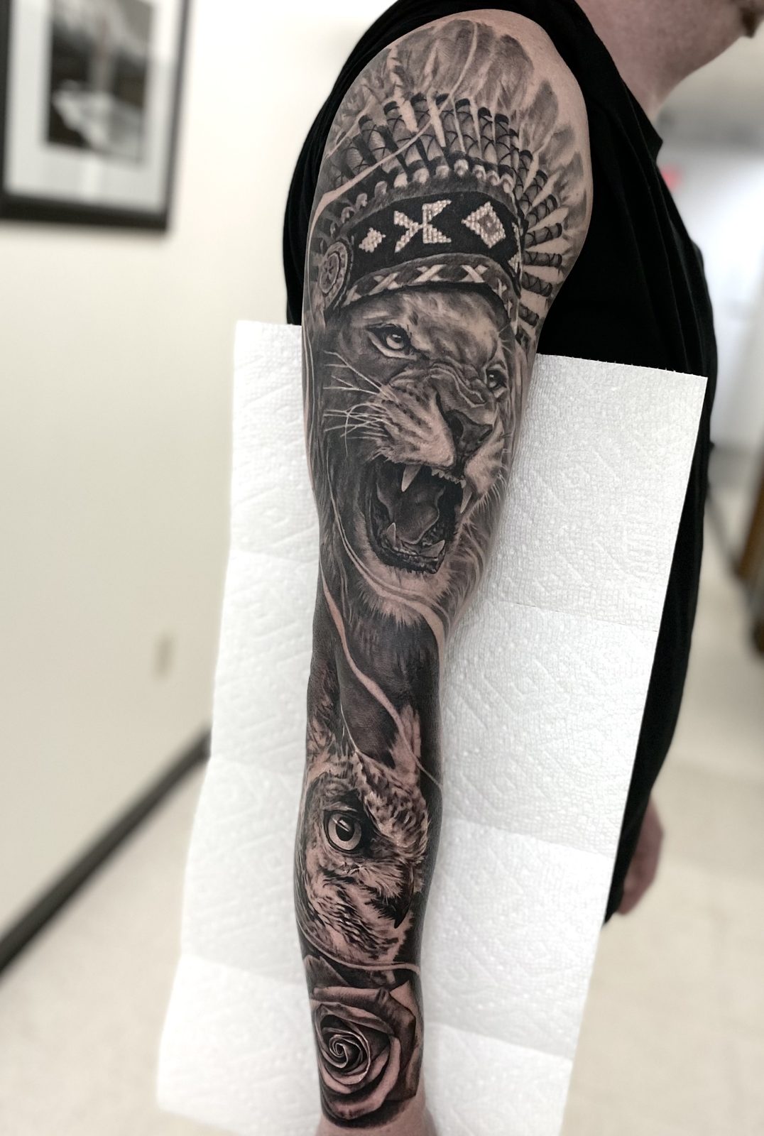 Roaring big cat in an ornate headdress, forearm