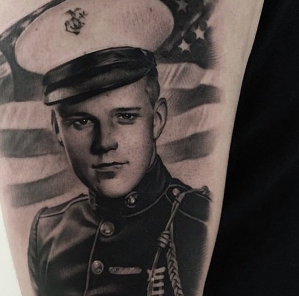 Portrait of a serviceman against the flag