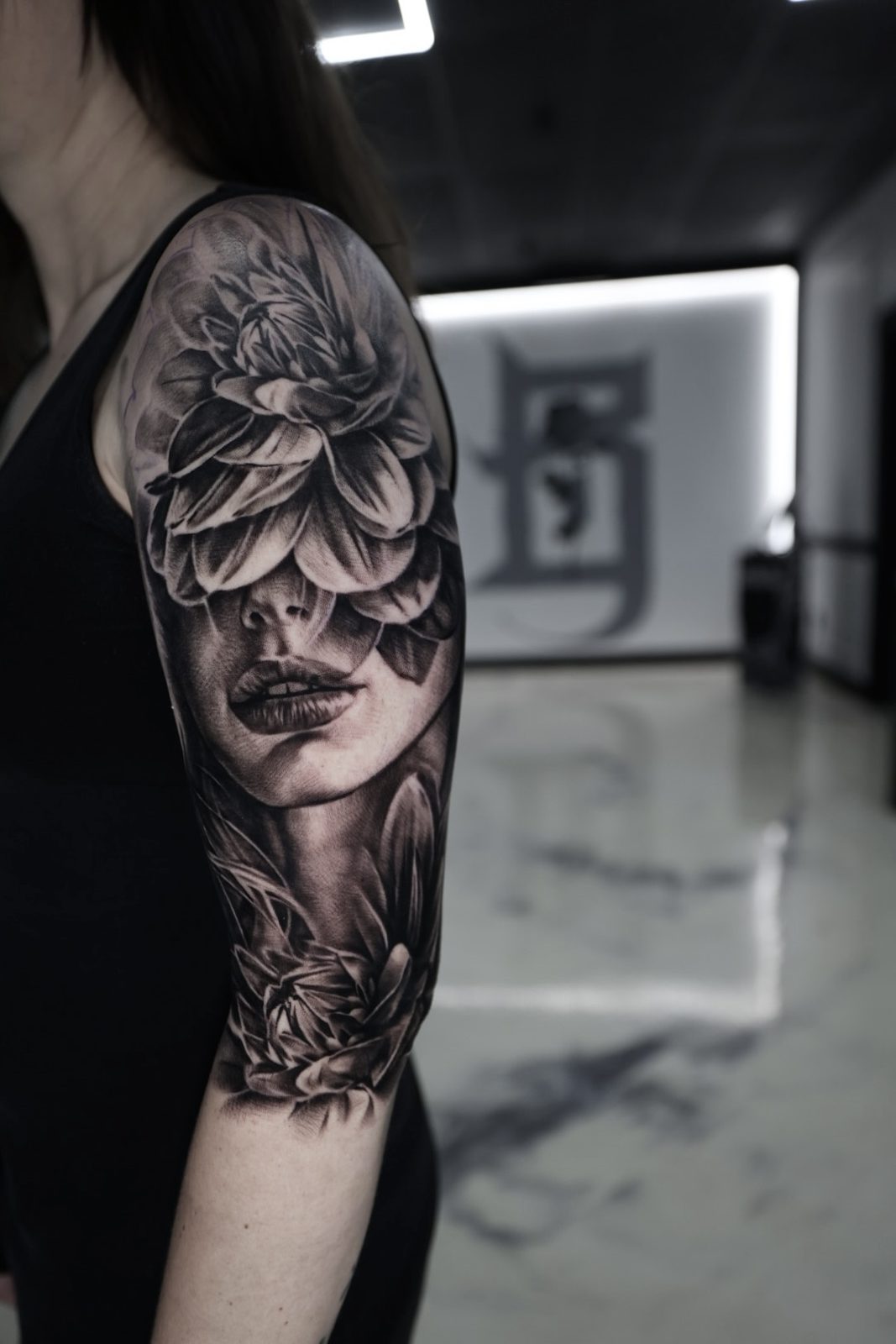 Woman’s portrait wrapped in roses, upper arm