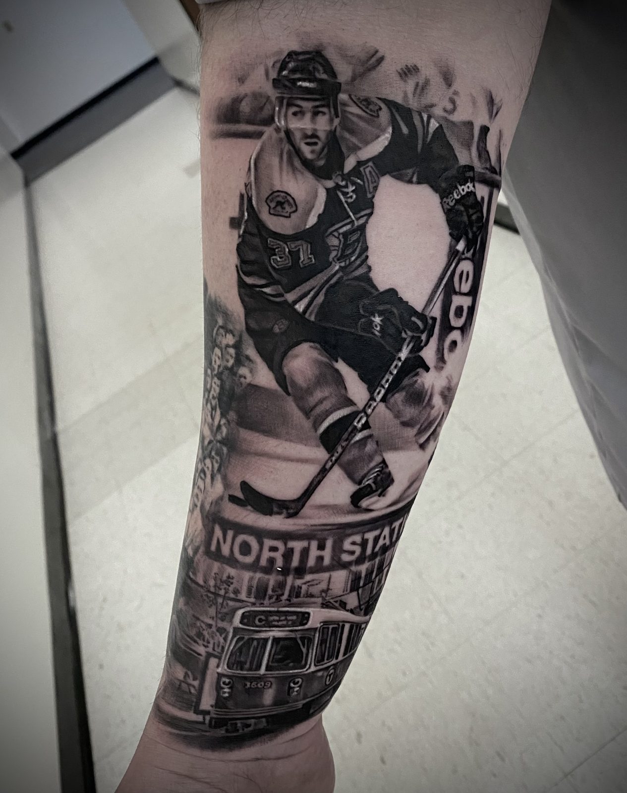 Hockey player and rink signage down the leg