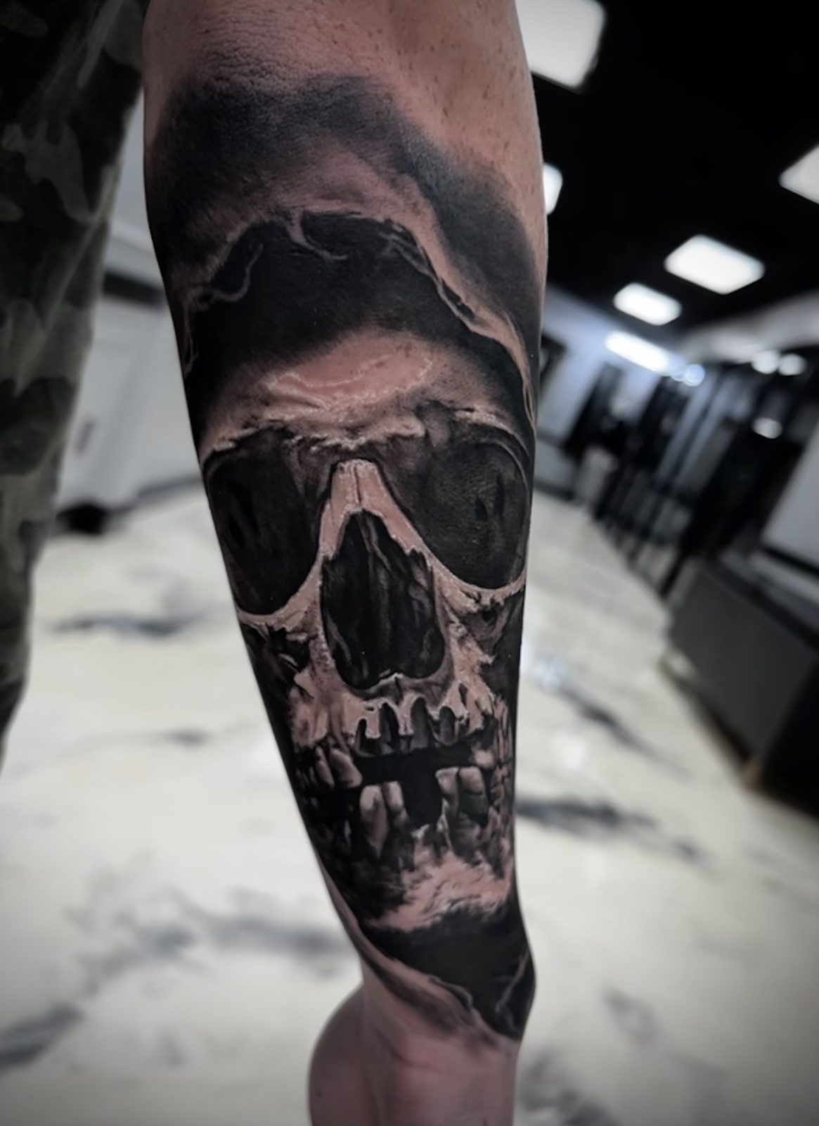 Skull breaking through cloud, forearm
