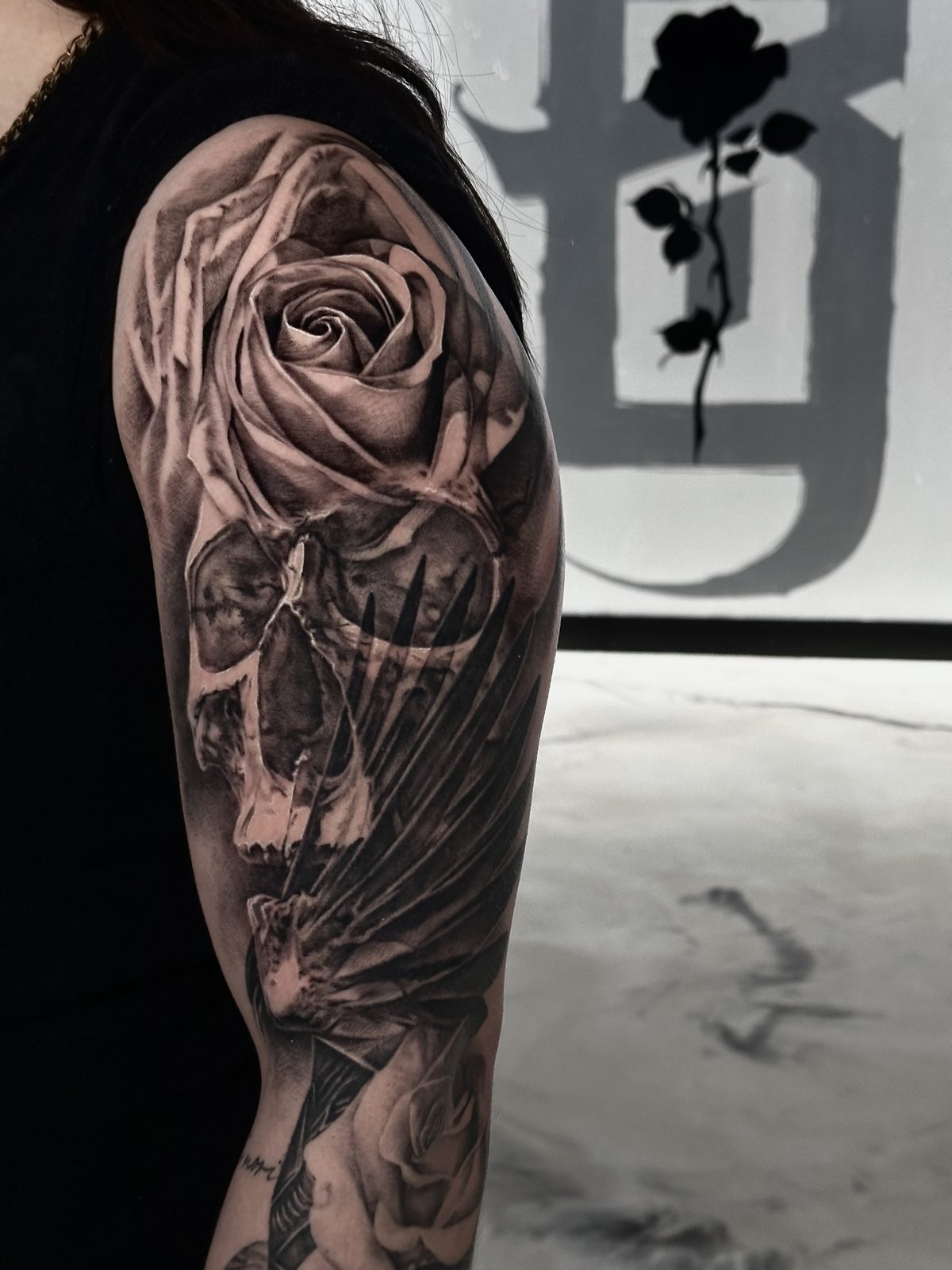 Rose over a skull and clasped hands