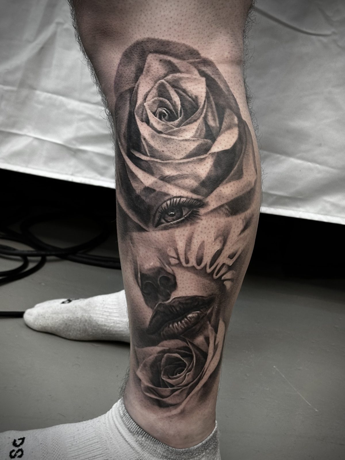 Rose and skull along the calf