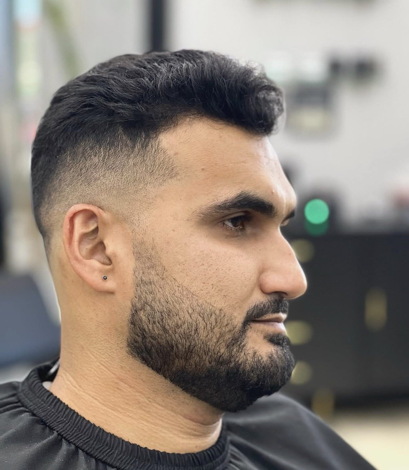 Mid fade with a shaped beard